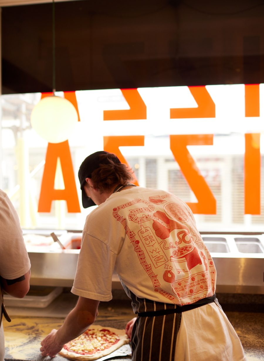 chef preparing pizza in kitchen